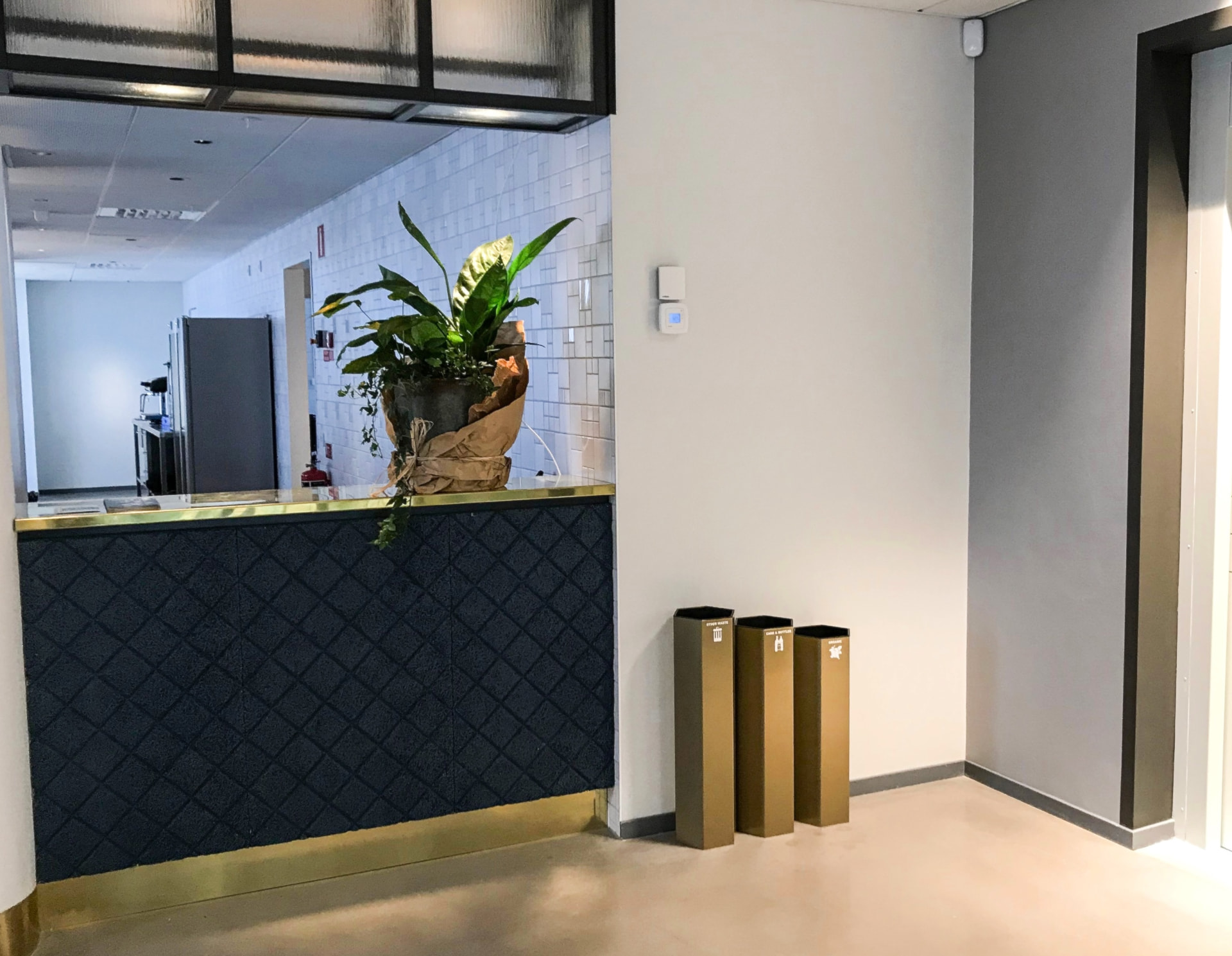 Guldfärgade Papaya-kärl intill receptionsdisken på Borås Kongress